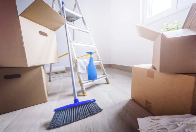 Empty room full of cardboard boxes and cleaning things for moving into a new home